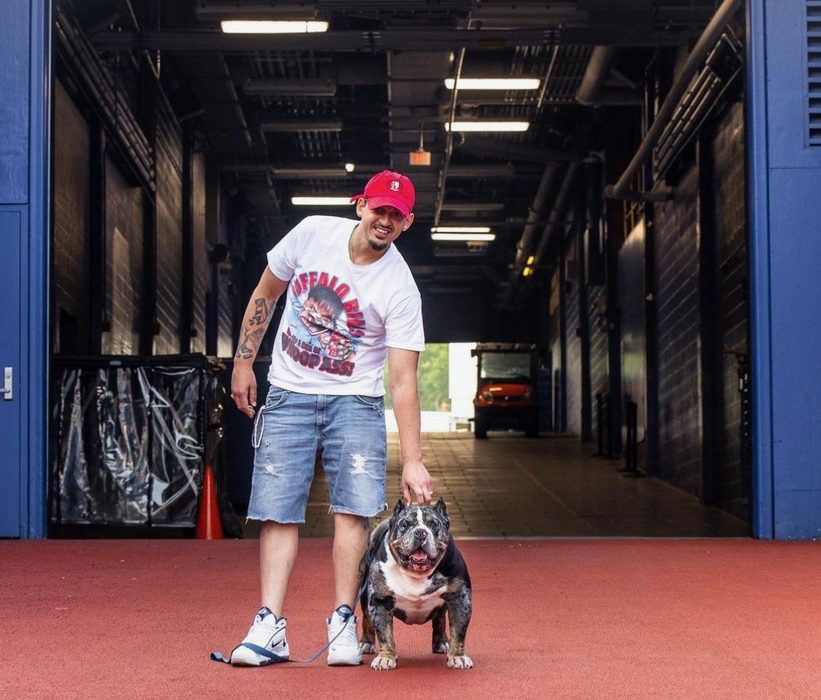 David Singh walks Famous through the players' tunnel of a football stadium.